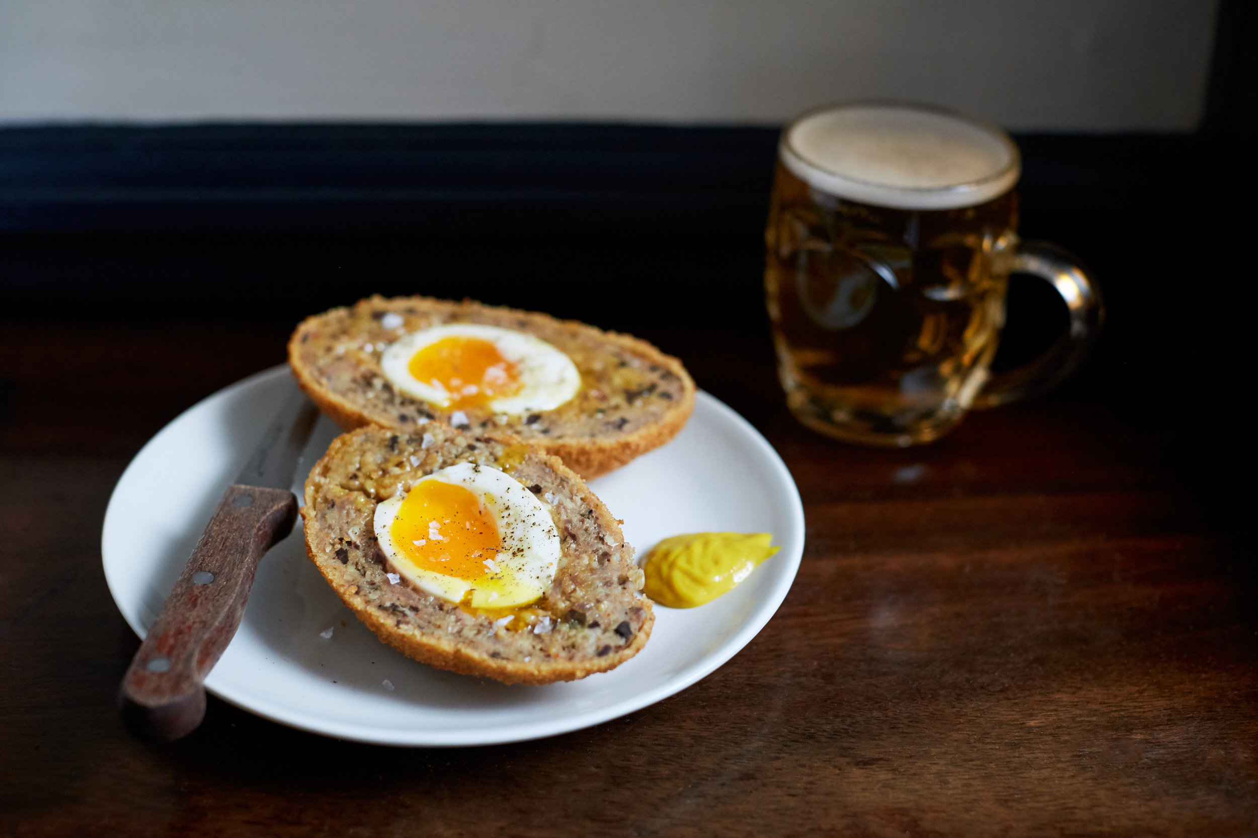 Scotch egg and a dimpled mug